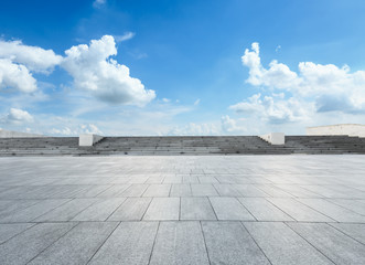 empty square floor and blue sky with white clouds in the daytime