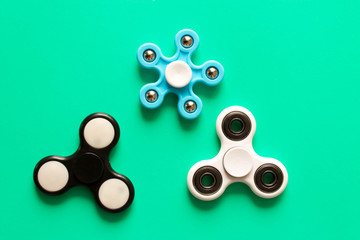 Several different fidget spinners . Isolated on blue background