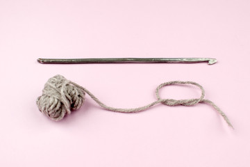Vintage rough hook and gray thread, concept of needlework, poverty, debt loop