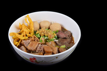 Spicy tom yum noodle soup with boiled pork and pork ball