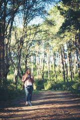 young woman walking in the forest