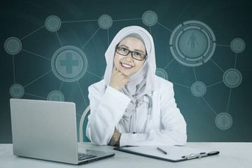 Muslim female doctor smiling at the camera