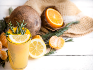 summer composition with fresh orange juice on a wooden background, concept of refreshing summer drinks and summer relaxation