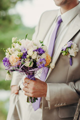 groom with flowers