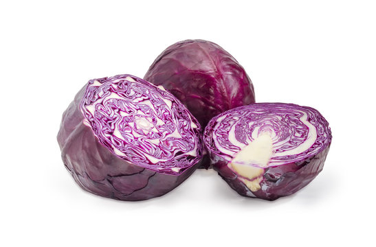 Halves and whole heads of red cabbage on white background