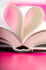 pages of a book curved into a heart shape