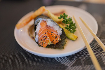 closeup of cinese food with sushi and vegetables seaweed cone