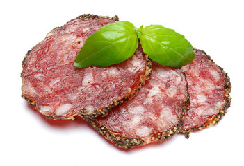 Dried organic salami sausage covered with pepper on white background