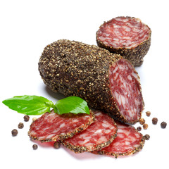 Dried organic salami sausage covered with pepper on white background