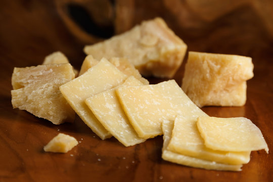Parmesan cheese on a wooden board. Close-up.