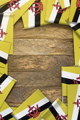Brunei small flags framing a wood texture background with copy space