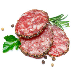 Dried organic salami sausage covered with pepper on white background