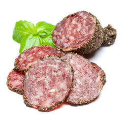 Dried organic salami sausage covered with pepper on white background