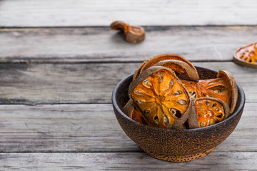 Dry Bael fruit - Slices of dry Bael fruit on the wooden table