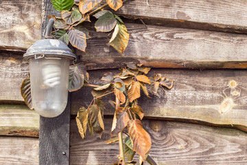 Old vintage lamp on wooden fence