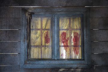 Bloodstained Red Fingerprints on Closed Wooden Window