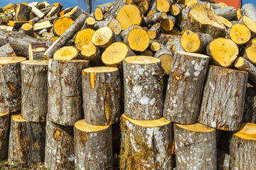 Stack of chopped firewood. Preparation of firewood for the winter.