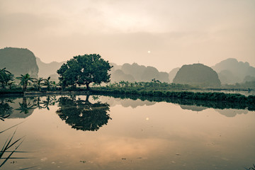the sun rises over this lake in Vietnam