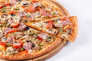 Italian kitchen and cooking concept. Hot tasty sliced with ham, sausage, jalapenos, mushrooms, tomato. Eat delivery concept.