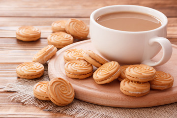 Slow morning latte coffee drink with sweet cookies on wooden table background