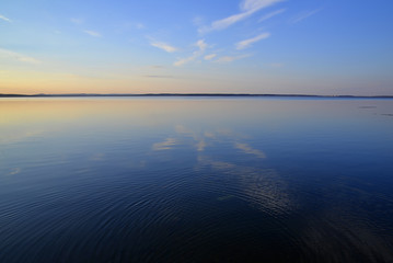 The landscape of the lake. The reflection of the sky in the water.