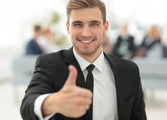 portrait of happy businessman showing thumb up.