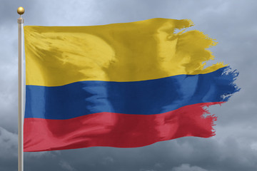 Columbia Flag with torn edges in front of a stormy sky