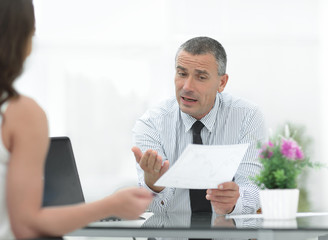 Fototapeta premium closeup. Manager discusses with the client the terms of the contract