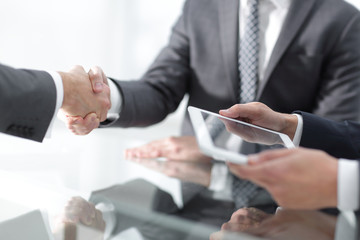 Two confident businessmen shaking hands during a meeting in the
