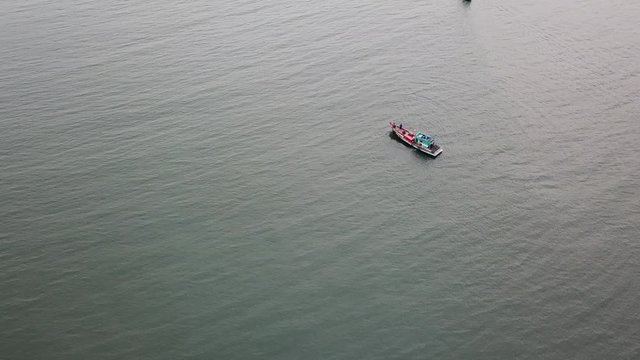 Top view. Aerial view from drone. Royalty high quality free stock footage of the fishing boat on the beach. Fishing boat is mooring on beach alone