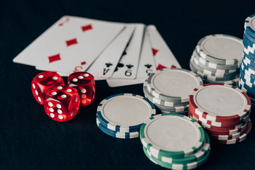 Dice with playing cards and chips on casino table