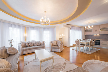 Interior of a luxury, open plan, apartment,living room with round, circle, ceiling, kitchen and dining area