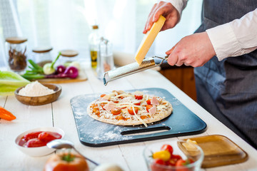 closeup hands of chef making fresh homemade traditional italian pizza. wallpaper for pizzeria and cooking food concept