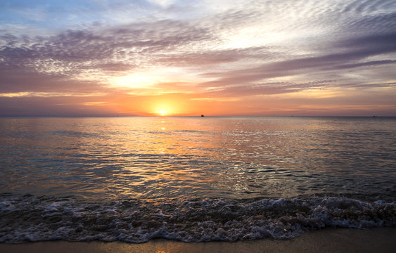 amazing sunset and silhouette of ships on a tropical island