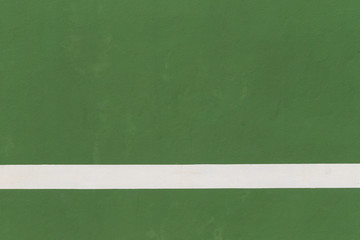 White lines of tennis courts on green floor background.