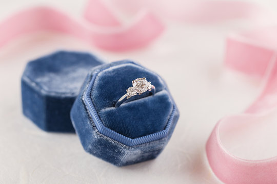 White golden wedding ring with diamonds in blue vintage velvet box