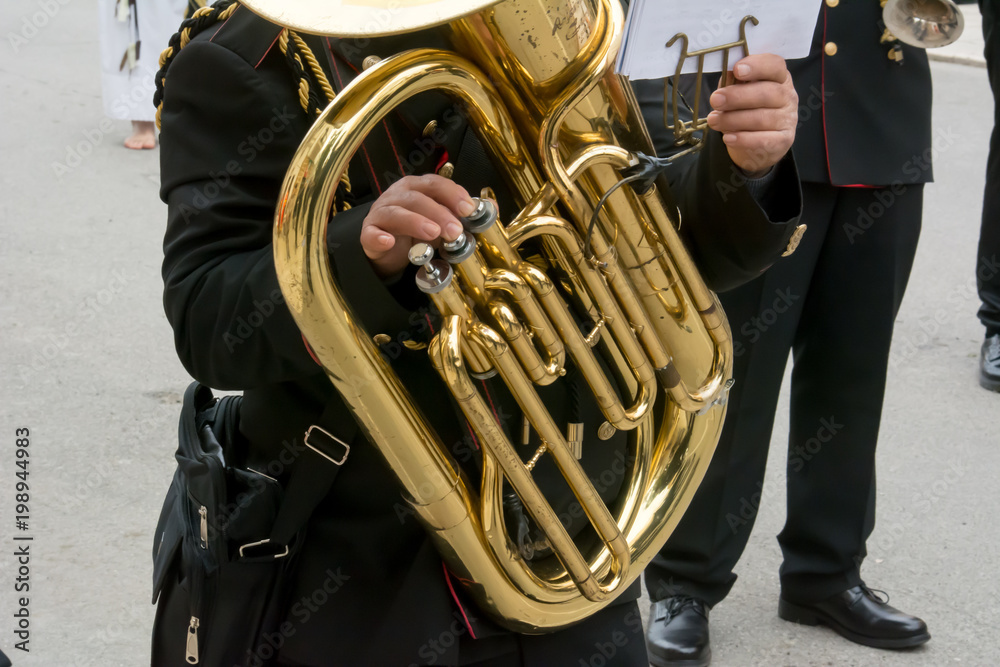 Wall mural Horizontal View of Close Up of Musician Playing Euphonuim in Black Uniform. Taranto, South of Italy