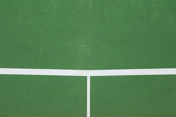 White lines of tennis courts on green floor background.
