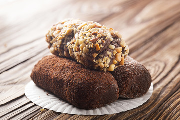 Chocolate cake on a wooden background. Three kinds of cakes.