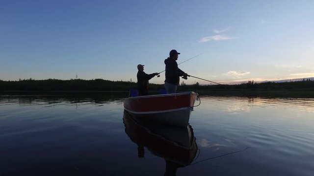 Men fishing at sunset