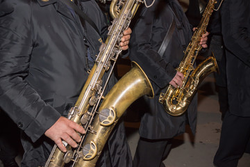 Horizontal View of Close Up of Musicians Playing Saxophone in Black Uniform. Taranto, South of Italy