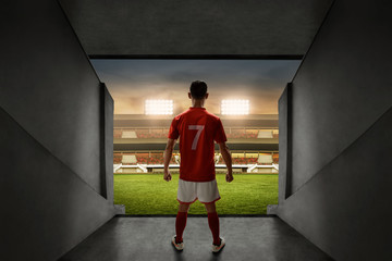 Soccer player standing on stadium entrance