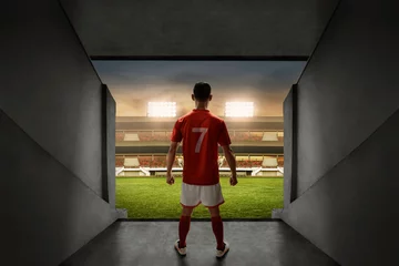 Fototapeten Soccer player standing on stadium entrance © fotokitas