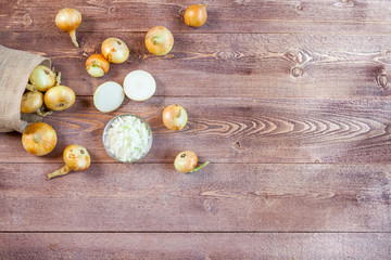 Fototapeta na wymiar fresh onions on a wooden table background with copy space for text. wallpaper for grocery shopping and cooking food concept. top view, flat lay