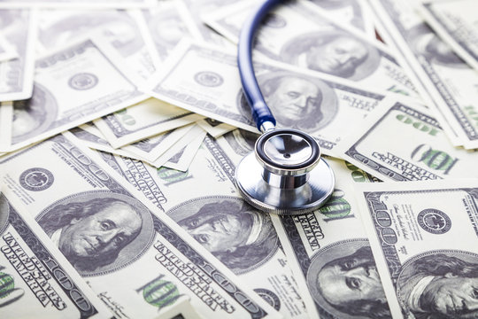 Stethoscope on dollars.