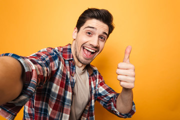 Portrait of a cheerful young man taking a selfie