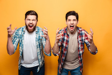 Portrait of a two angry young men shouting loud