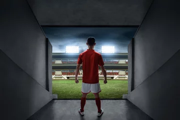 Zelfklevend Fotobehang Soccer player standing on stadium entrance © fotokitas