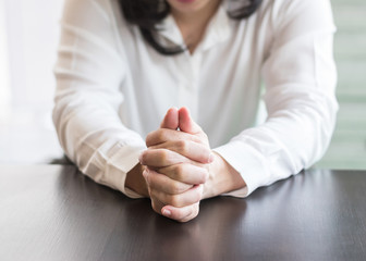 Woman prayer's hands holding together praying in for religious holy spirit, forgiveness, mourning in silence concept.