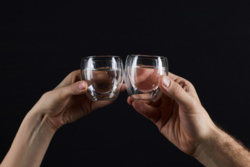 cropped shot of man and woman clinking glassed isolated on black